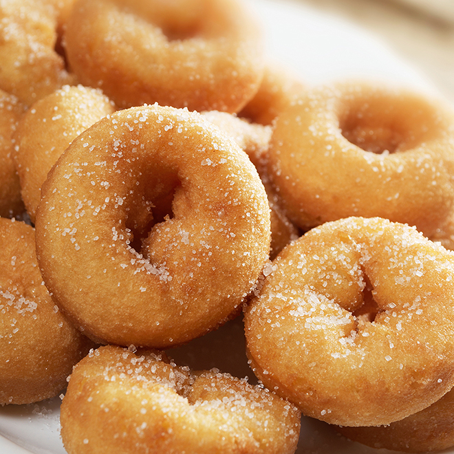 close up of mini donuts covered in sugar