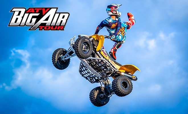 Derek Guetter performs a Switchblade trick in midair during the ATV Big Air Tour