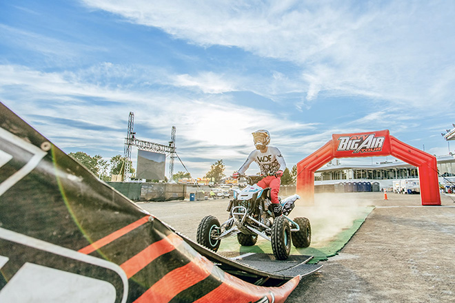 a man on an ATV approaches a big jump