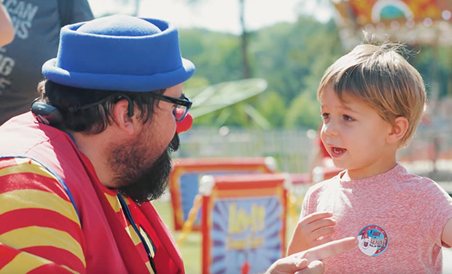 Lew-E the clown talks with a little boy