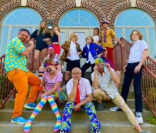 The Dweebs members wearing brightly colored clothing pose for a photo
