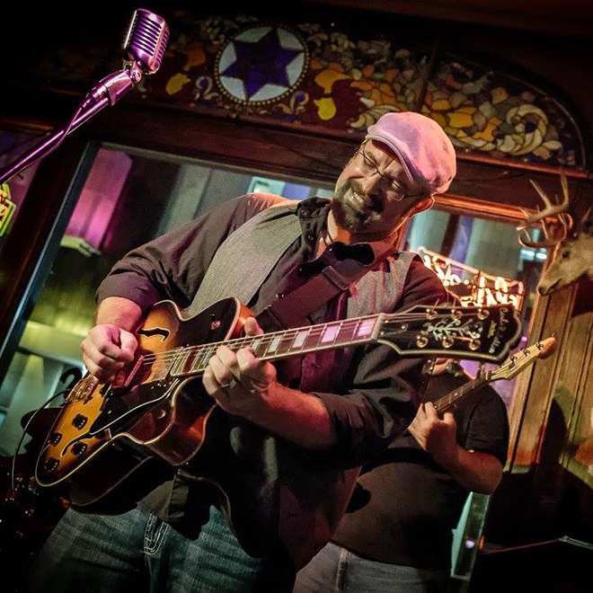 Jason Paulson playing guitar