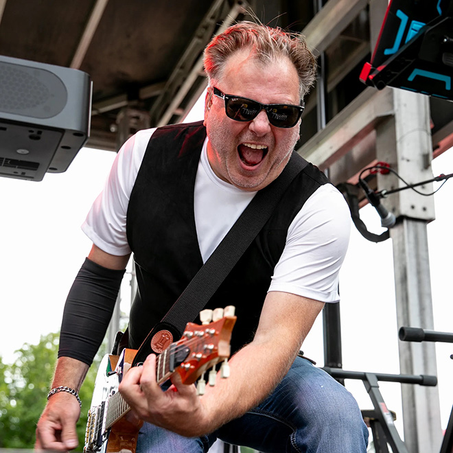 Muddcat Melby playing guitar